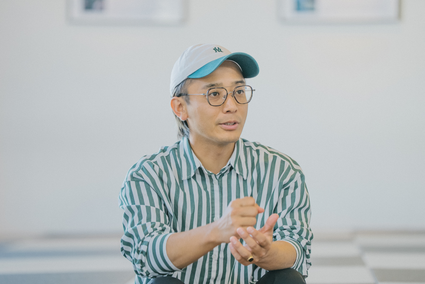 【写真】こちらを向いて話す、キャップをかぶった男性