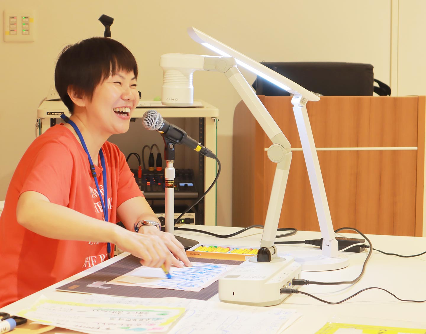 マイクの前で笑顔で話している高橋さんの写真。