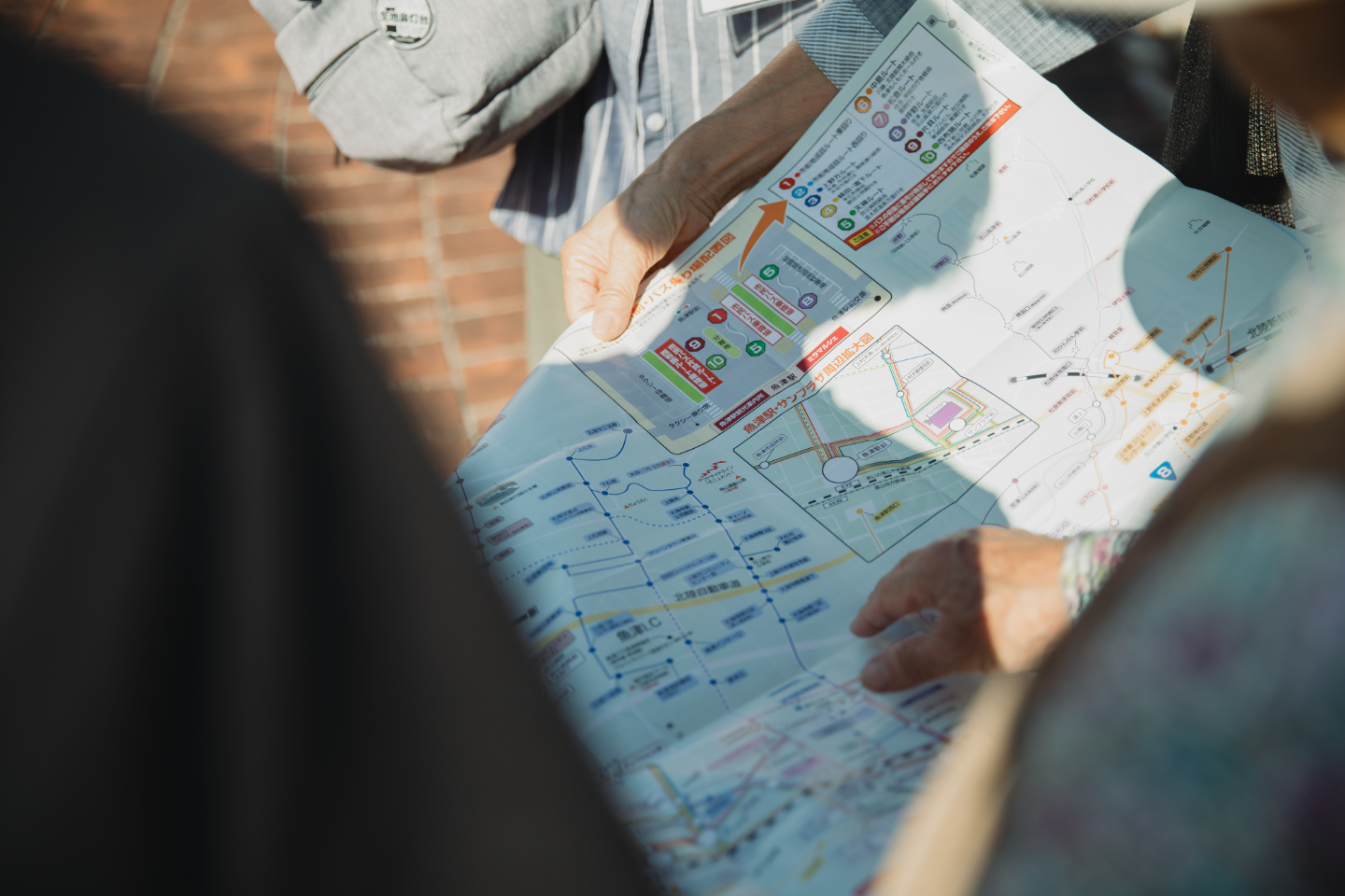 【写真】複数人で地図を広げ、指で確認している