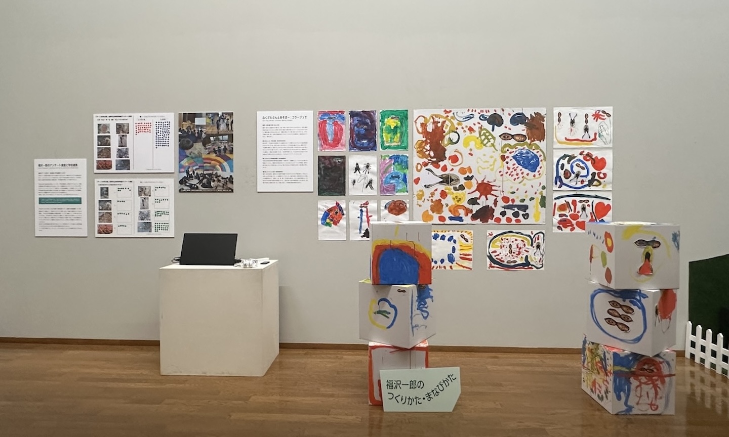 イラストが壁一面に貼られている展示の様子